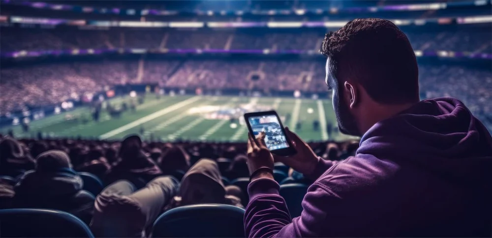 Apostas no telemóvel durante um jogo